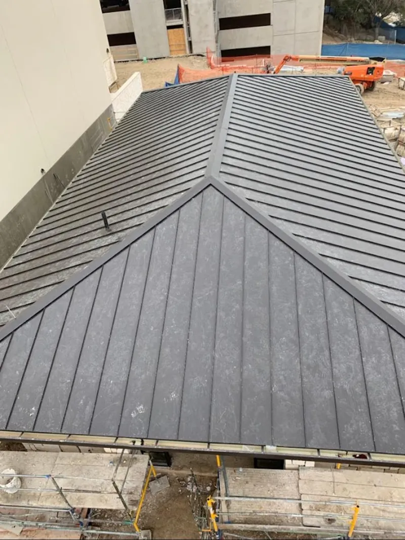 Commercial metal roof construction with crane equipment in Shelbyville